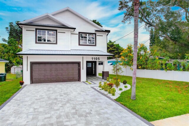 view of front facade with a garage and a front yard