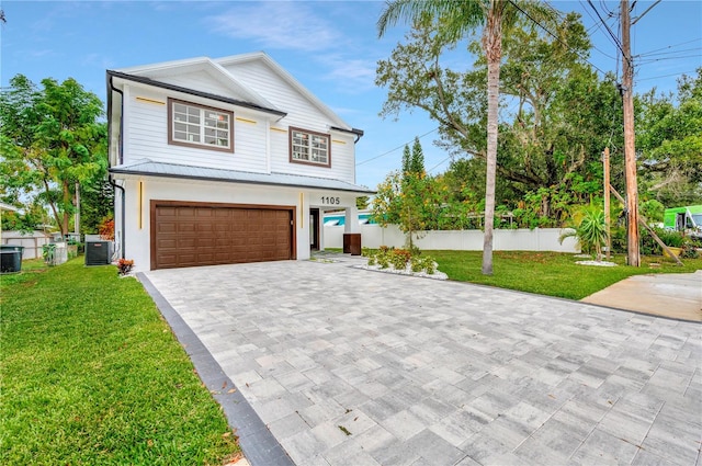 front facade featuring cooling unit, a garage, and a front lawn