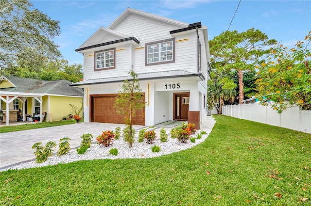 view of front facade with a garage and a front lawn