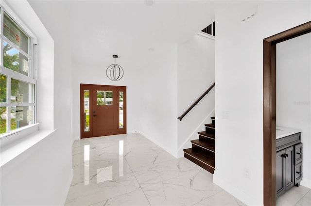 foyer entrance with a high ceiling and plenty of natural light