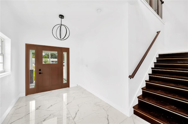 entrance foyer featuring a towering ceiling