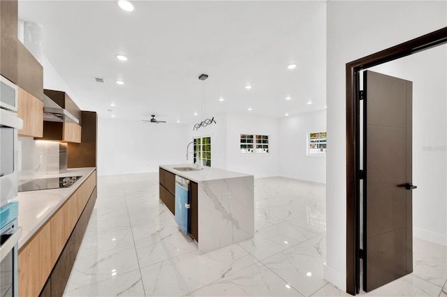 kitchen with an island with sink, plenty of natural light, ceiling fan, and appliances with stainless steel finishes