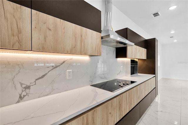 kitchen with backsplash, light brown cabinetry, light stone counters, wall chimney exhaust hood, and black electric stovetop