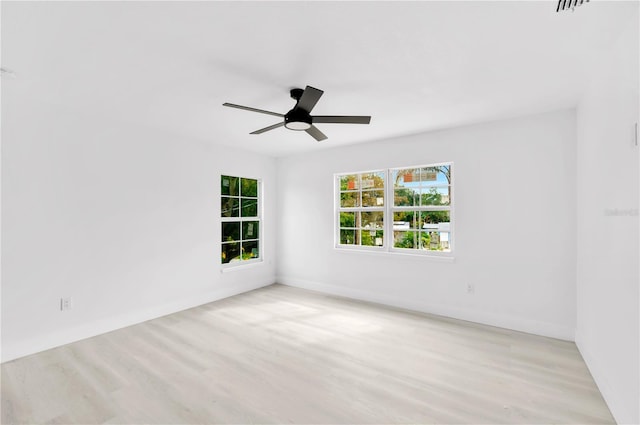 empty room with light wood-type flooring and ceiling fan