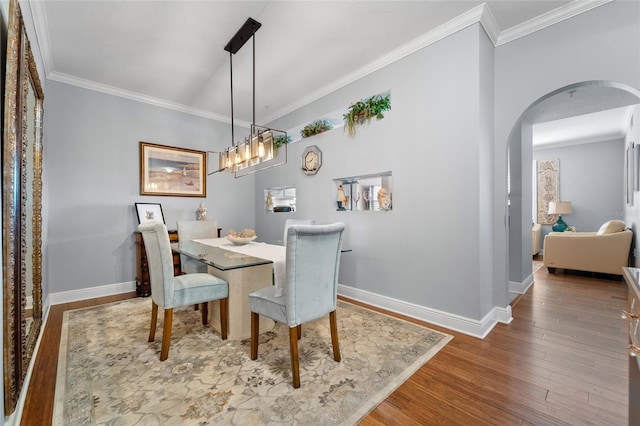 501 Knights Run Ave Unit 2120, Tampa, FL 33602 - dining space featuring baseboards, wood finished floors, arched walkways, and ornamental molding