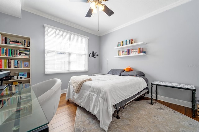 bedroom featuring ceiling fan, ornamental molding, and wood-type flooring