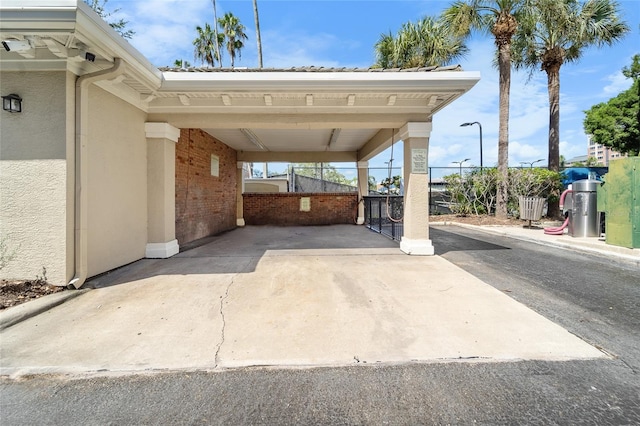 view of parking / parking lot featuring a carport