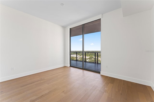 spare room with light hardwood / wood-style flooring