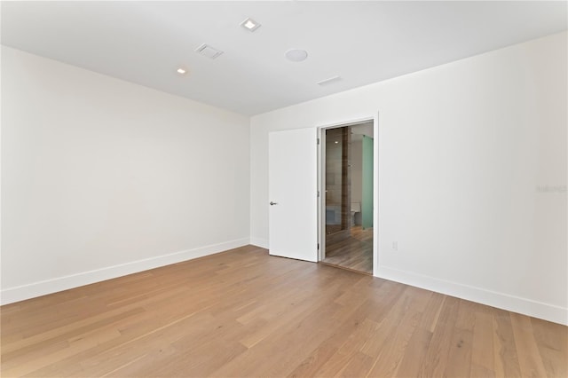 spare room featuring light hardwood / wood-style floors