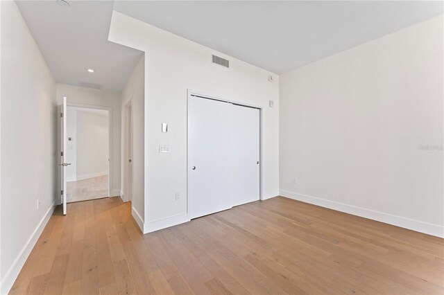 unfurnished bedroom with light wood-type flooring