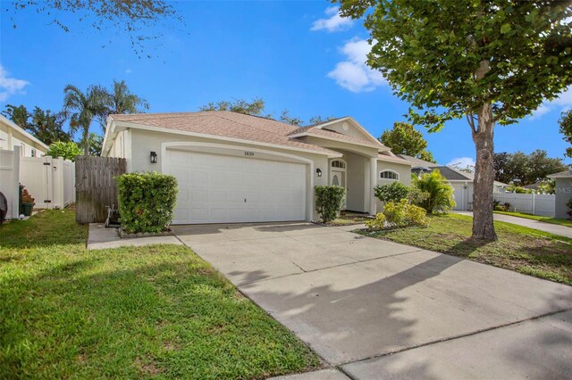 view of front facade with a garage and a front yard