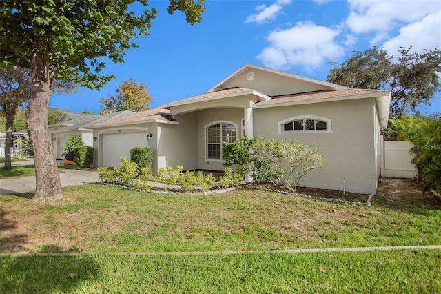 view of front of property with concrete driveway, a front yard, an attached garage, and stucco siding