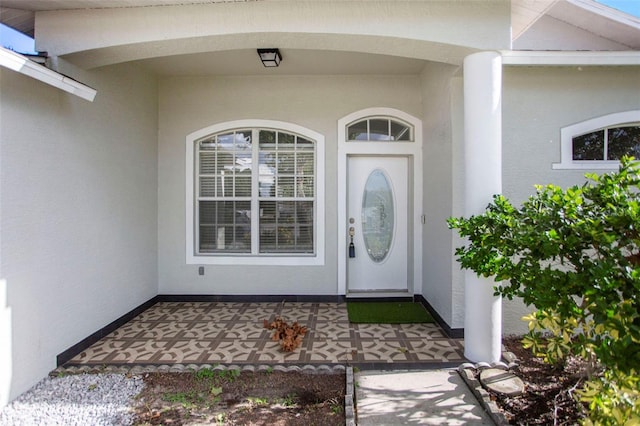 entrance to property with stucco siding