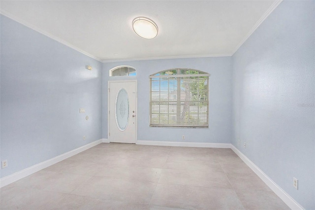 foyer with ornamental molding and baseboards