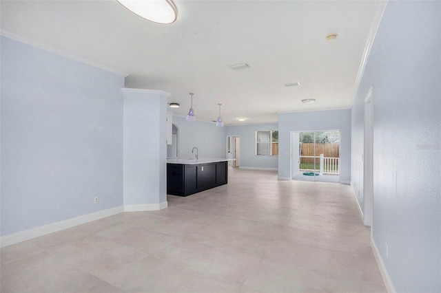 unfurnished living room featuring ornamental molding and sink