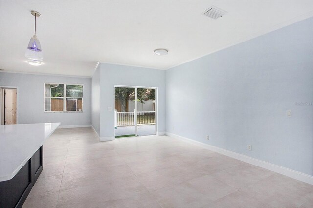 empty room featuring crown molding