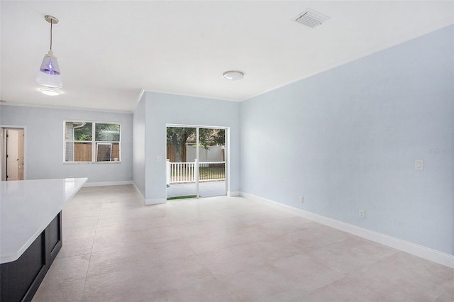 interior space featuring crown molding, visible vents, and baseboards