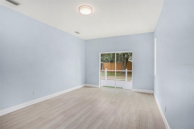 empty room with light hardwood / wood-style floors