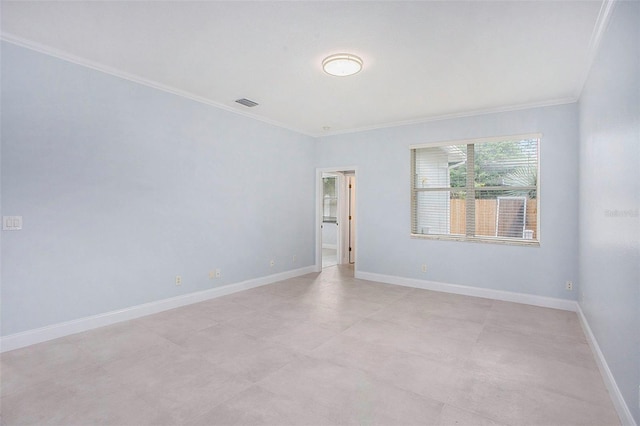 unfurnished room with visible vents, baseboards, and ornamental molding