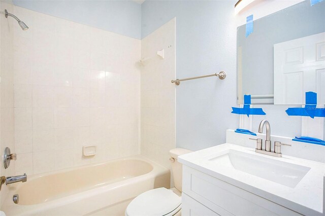 full bathroom with vanity, toilet, and tiled shower / bath