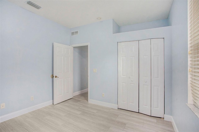 unfurnished bedroom featuring light wood-style floors, visible vents, and baseboards