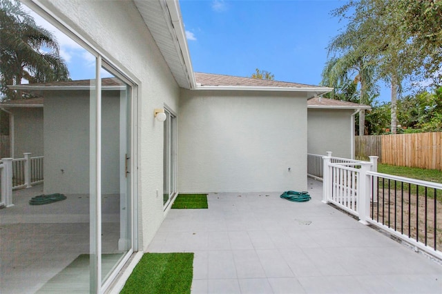 view of patio featuring fence