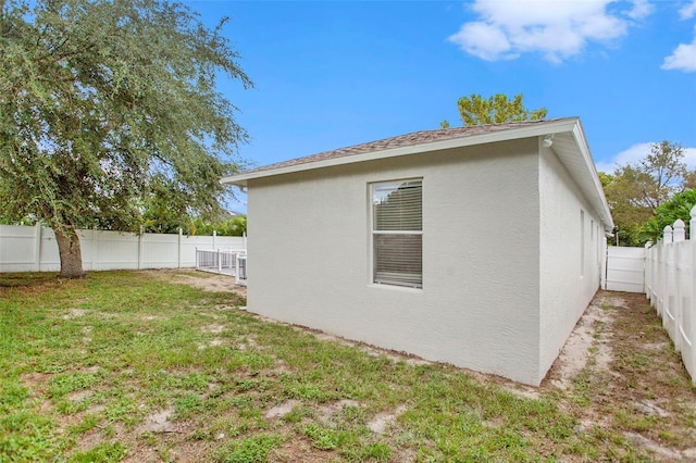 view of home's exterior featuring a fenced backyard, a yard, and stucco siding