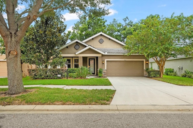 view of front of home featuring a garage and a front lawn