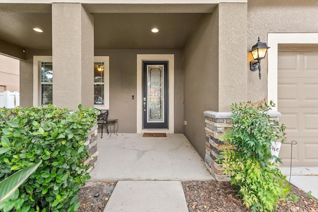 doorway to property with a garage