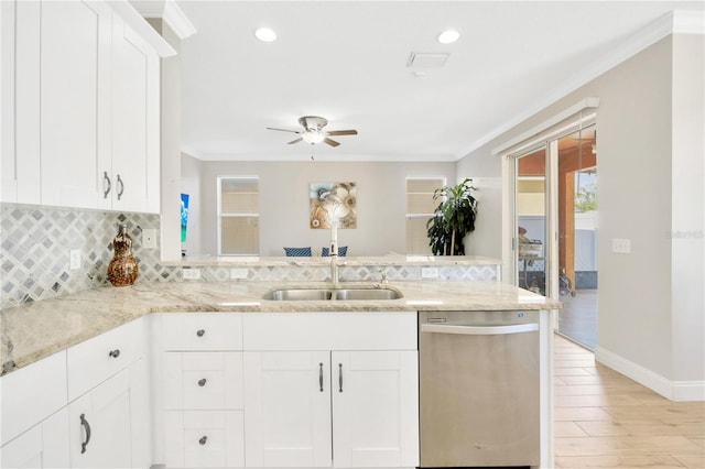 kitchen with dishwasher, kitchen peninsula, white cabinets, and sink