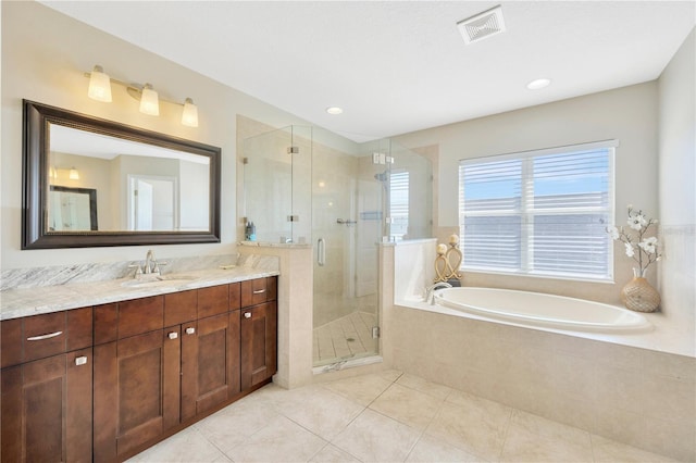 bathroom with tile patterned flooring, shower with separate bathtub, and vanity