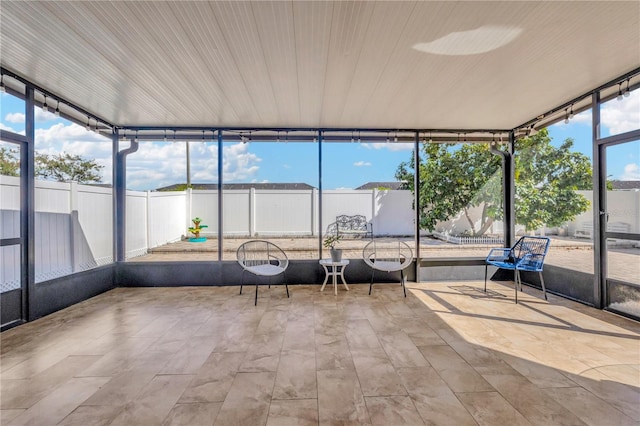 unfurnished sunroom featuring a healthy amount of sunlight