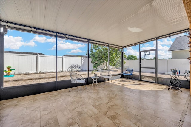 unfurnished sunroom with plenty of natural light