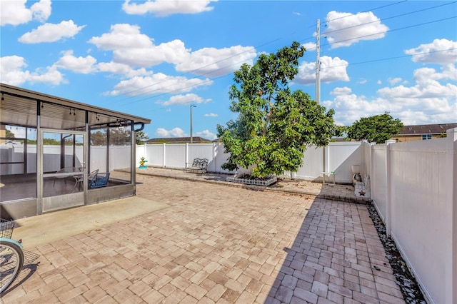 view of patio with a sunroom