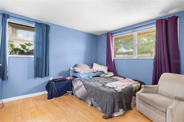 bedroom featuring light hardwood / wood-style floors and multiple windows