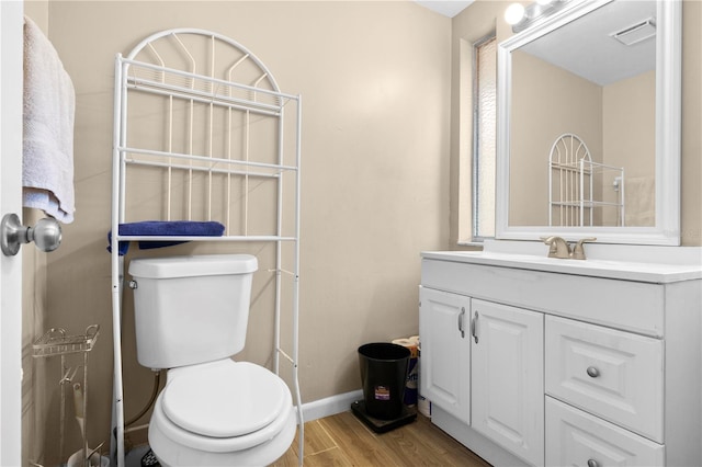 bathroom featuring hardwood / wood-style flooring, vanity, and toilet