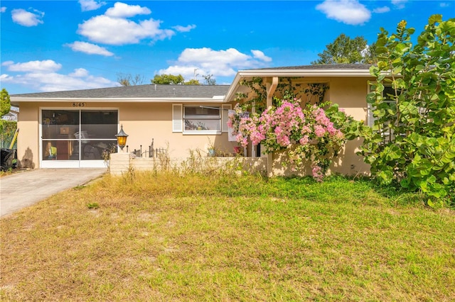 rear view of property featuring a lawn