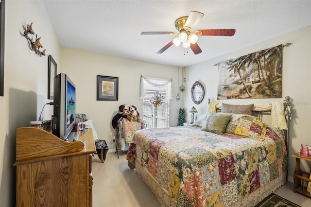 carpeted bedroom featuring a textured ceiling and ceiling fan