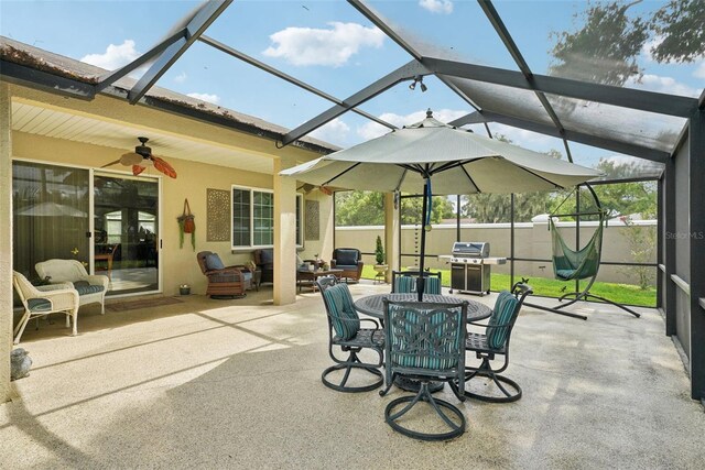 view of patio with a lanai, a grill, and ceiling fan