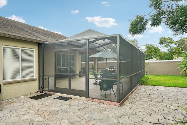 view of patio / terrace featuring a lanai