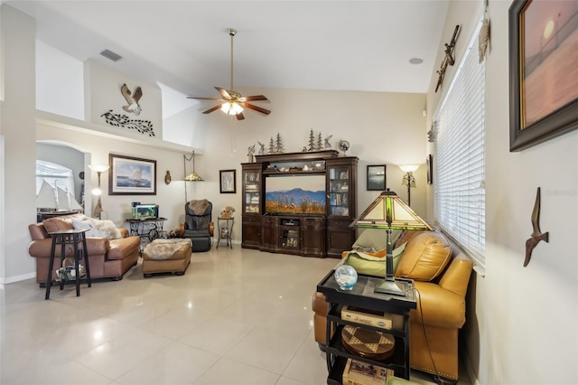 living room with high vaulted ceiling, ceiling fan, and light tile patterned floors