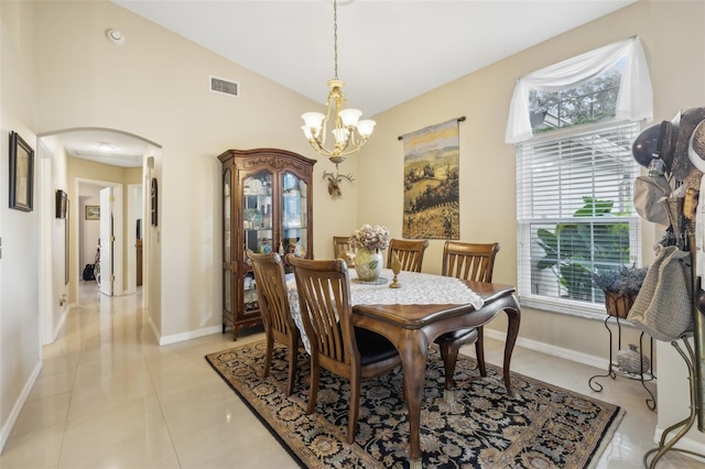 dining room with a wealth of natural light, light tile patterned floors, a chandelier, and lofted ceiling