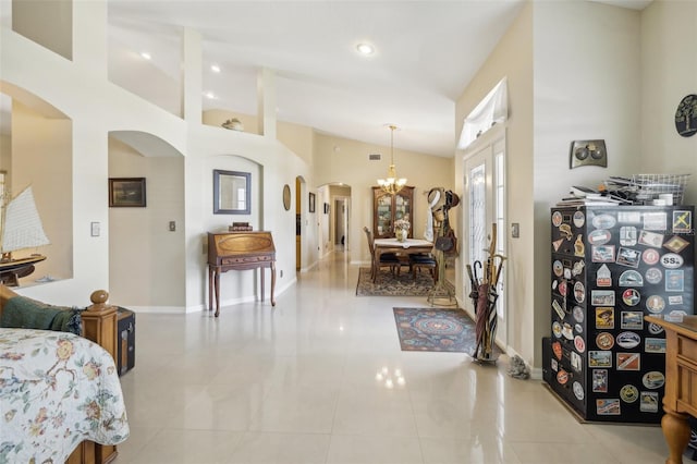 interior space with lofted ceiling, light tile patterned floors, and an inviting chandelier