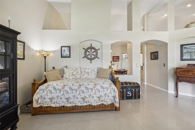 tiled bedroom with a towering ceiling