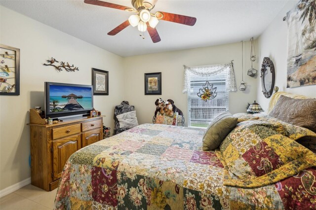 tiled bedroom featuring ceiling fan