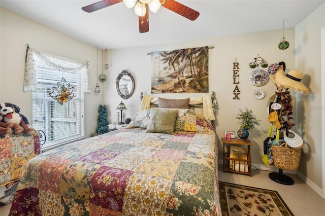 tiled bedroom featuring ceiling fan