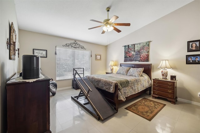 tiled bedroom with ceiling fan and vaulted ceiling