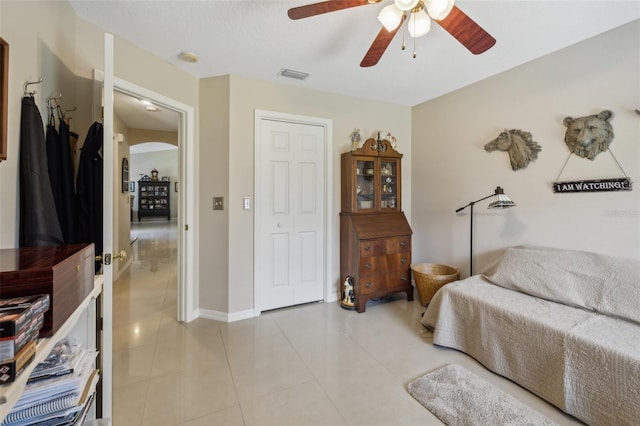 living room featuring light tile patterned floors and ceiling fan