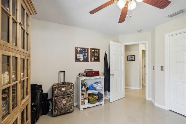 interior space with ceiling fan