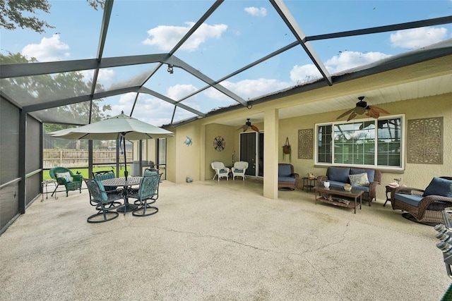 view of patio / terrace with glass enclosure, ceiling fan, and an outdoor hangout area